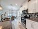 Beautiful kitchen with stainless steel appliances, granite countertops, modern cabinetry, and tile backsplash at 8855 Prairie Creek Dr, New Port Richey, FL 34655