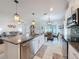 Bright, open kitchen featuring granite countertops, stainless steel appliances, and pendant lighting at 8855 Prairie Creek Dr, New Port Richey, FL 34655