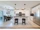 Modern kitchen boasts a large island, stainless steel appliances, granite countertops, and pendant lighting at 8855 Prairie Creek Dr, New Port Richey, FL 34655