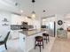 Bright kitchen with a large island, granite countertops, stainless steel appliances and white cabinetry at 8855 Prairie Creek Dr, New Port Richey, FL 34655
