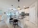 Open-concept kitchen featuring an island, pendant lights, stainless steel appliances, and tiled flooring at 8855 Prairie Creek Dr, New Port Richey, FL 34655