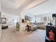 Comfortable living room with a neutral color palette, carpet flooring, and ample natural light at 8855 Prairie Creek Dr, New Port Richey, FL 34655