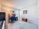 Home office with a work desk, a large window that offers natural light, and a wooden storage bench at 8855 Prairie Creek Dr, New Port Richey, FL 34655