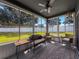 Enclosed sunroom with lots of natural light from the large windows that overlook the fenced-in backyard at 8855 Prairie Creek Dr, New Port Richey, FL 34655