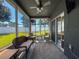 Interior view of sunroom with ceiling fan, rug and furnishings at 8855 Prairie Creek Dr, New Port Richey, FL 34655