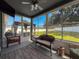 Cozy sunroom with wicker furnishings, and large windows offering a relaxing view of the outdoors at 8855 Prairie Creek Dr, New Port Richey, FL 34655