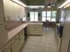 Bright kitchen area features abundant cabinetry, tile floors, and access to a cozy breakfast nook at 9168 Southern Comfort Ct, Weeki Wachee, FL 34613