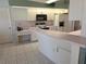 Functional kitchen with white cabinets, classic appliances, and a convenient breakfast bar at 9168 Southern Comfort Ct, Weeki Wachee, FL 34613
