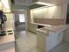Well-maintained kitchen featuring ample counter space, white cabinets, and a breakfast bar at 9168 Southern Comfort Ct, Weeki Wachee, FL 34613