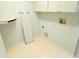 Convenient laundry area with practical features like an ironing board and overhead cabinets at 9168 Southern Comfort Ct, Weeki Wachee, FL 34613