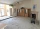 Open-concept living room featuring neutral carpeting, tall ceilings, and a cozy fireplace at 9168 Southern Comfort Ct, Weeki Wachee, FL 34613