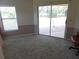 Bright living room with sliding glass doors leading to the outdoors at 9168 Southern Comfort Ct, Weeki Wachee, FL 34613