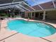 Enjoy the spacious screened-in pool with access to the home's back patio and outdoor seating at 9168 Southern Comfort Ct, Weeki Wachee, FL 34613