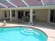 Dive into this inviting pool with convenient steps and a view of the covered patio for relaxation at 9168 Southern Comfort Ct, Weeki Wachee, FL 34613