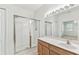Bright bathroom featuring glass shower, tile floors, and wood vanity at 9420 Georgian Park Ln # 106, Tampa, FL 33626