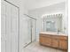 Bright bathroom with glass shower, tiled floors, and wood vanity at 9420 Georgian Park Ln # 106, Tampa, FL 33626