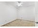 Bedroom featuring carpeted floors, a ceiling fan, and a partial view of a door and baseboard at 9420 Georgian Park Ln # 106, Tampa, FL 33626