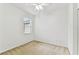 Neutral bedroom with carpet, ceiling fan, and a window that provides natural light at 9420 Georgian Park Ln # 106, Tampa, FL 33626