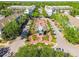 Aerial view of a community park with benches and a fountain area lined with mature trees and sidewalks at 9420 Georgian Park Ln # 106, Tampa, FL 33626