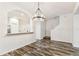 Open-concept dining room with modern light fixture and wood-look floors at 9420 Georgian Park Ln # 106, Tampa, FL 33626