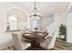 This dining room features a modern light fixture and wood-look floors at 9420 Georgian Park Ln # 106, Tampa, FL 33626