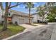 Townhome exterior with garage, landscaping, and a well-maintained facade at 9420 Georgian Park Ln # 106, Tampa, FL 33626