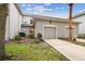 Two-story home with a two-car garage, well-maintained landscaping, and a concrete driveway at 9420 Georgian Park Ln # 106, Tampa, FL 33626