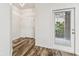 Bright foyer with wood floors, white trim, and natural light from an exterior door at 9420 Georgian Park Ln # 106, Tampa, FL 33626