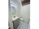 Chic half bathroom with patterned tile, modern vanity, and decorative lighting at 9420 Georgian Park Ln # 106, Tampa, FL 33626