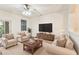 Comfortable living room with neutral furniture, large TV, and bright natural light at 9420 Georgian Park Ln # 106, Tampa, FL 33626