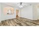 Open living space with hardwood floors and connection to the adjacent kitchen at 9420 Georgian Park Ln # 106, Tampa, FL 33626
