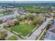 Aerial view of a community park with lush landscaping and green space surrounded by houses at 9420 Georgian Park Ln # 106, Tampa, FL 33626