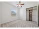 Neutral bedroom featuring carpet, closet, and a window, plus an exposed wire shelf system at 9829 Sorbonne Loop, Seffner, FL 33584