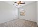 Light and airy bedroom with carpet, closet, ceiling fan, and a large window at 9829 Sorbonne Loop, Seffner, FL 33584