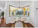 Bright breakfast nook featuring a round table with seating and a bay window overlooking the pool at 9829 Sorbonne Loop, Seffner, FL 33584
