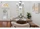 Bright dining room with hardwood floors, large windows, modern chandelier, and an inviting dining table arrangement at 9829 Sorbonne Loop, Seffner, FL 33584