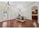 Elegant dining room with hardwood floors, decorative lighting, and a sophisticated table setting near a stylish doorway at 9829 Sorbonne Loop, Seffner, FL 33584
