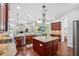 Gourmet kitchen with granite countertops, stainless steel appliances, hardwood floors, and an open floor plan at 9829 Sorbonne Loop, Seffner, FL 33584
