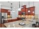 Spacious kitchen with granite countertops, stainless steel appliances, and dark wood cabinets with ample counter space at 9829 Sorbonne Loop, Seffner, FL 33584