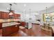 Open-concept kitchen with granite countertops, cherry cabinets, stainless steel appliances, and a view to the living area at 9829 Sorbonne Loop, Seffner, FL 33584