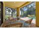 Relax on the screened lanai offering scenic views of the pool, spa, lush landscaping, and lake at 9829 Sorbonne Loop, Seffner, FL 33584