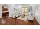 Cozy living space with hardwood floors, comfortable seating arrangement, and natural light near an archway at 9829 Sorbonne Loop, Seffner, FL 33584