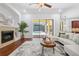 Cozy living room with fireplace and sliding glass doors that lead to the screened-in pool area at 9829 Sorbonne Loop, Seffner, FL 33584