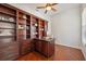 Office with dark wood built-in shelving, hardwood floors, and plenty of natural light at 9829 Sorbonne Loop, Seffner, FL 33584