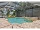 Captivating swimming pool and spa with a screened enclosure, waterfall feature and tile accents at 9829 Sorbonne Loop, Seffner, FL 33584