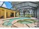 This luxury pool and spa boasts a screened enclosure, a waterfall feature, and plenty of lounging space at 9829 Sorbonne Loop, Seffner, FL 33584