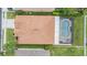 Aerial view of a home with a private screened-in pool and lush green backyard at 10435 Peppergrass Ct, Trinity, FL 34655