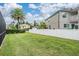 Expansive backyard features lush green grass and a white vinyl fence for privacy at 10435 Peppergrass Ct, Trinity, FL 34655
