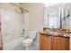 Bathroom features a shower-tub combo and granite sink countertop at 10435 Peppergrass Ct, Trinity, FL 34655