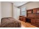Cozy bedroom features wood floors, a large closet, and an attractive matching desk and shelving at 10435 Peppergrass Ct, Trinity, FL 34655